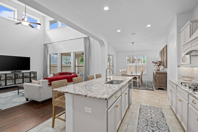 27121 Holtwood Grove Rd, Magnolia, TX 77354 - kitchen with a sink, a ceiling fan, light stone countertops, recessed lighting, and open floor plan