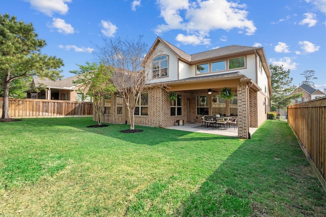 27121 Holtwood Grove Rd, Magnolia, TX 77354 - back of house featuring ceiling fan, stucco siding, brick siding, and a patio