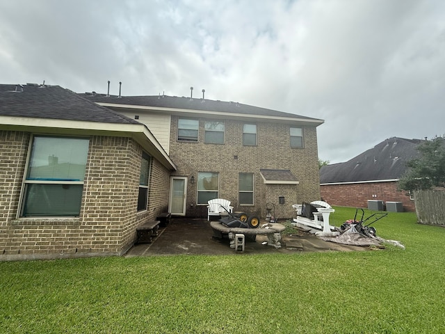422 Old Orchard Dr, Dickinson, TX 77539 - rear view of house featuring a patio, a lawn, brick siding, and central AC