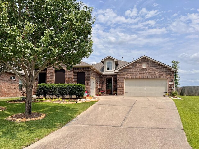 115 Carriage Ct, Magnolia, TX 77354 - view of front of property featuring an attached garage, brick siding, concrete driveway, and roof with shingles