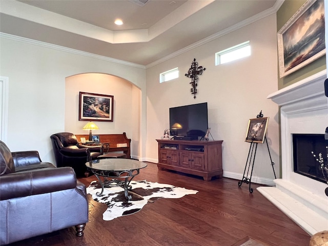 115 Carriage Ct, Magnolia, TX 77354 - living room with arched walkways, wood finished floors, baseboards, a raised ceiling, and ornamental molding