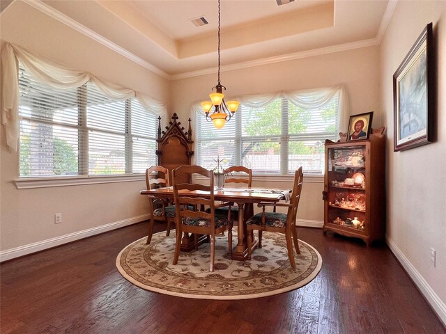 115 Carriage Ct, Magnolia, TX 77354 - dining area with a raised ceiling, dark wood-type flooring, healthy amount of natural light, a chandelier, and ornamental molding