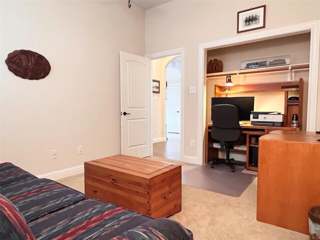 115 Carriage Ct, Magnolia, TX 77354 - carpeted home office featuring baseboards and arched walkways