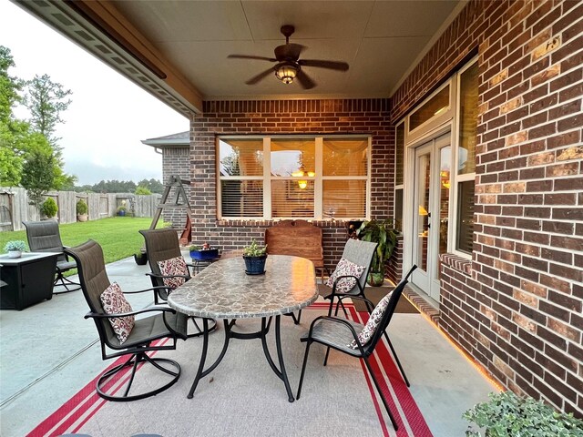 115 Carriage Ct, Magnolia, TX 77354 - view of patio / terrace with a ceiling fan and outdoor dining area
