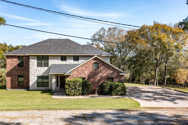 507 Oaks Grande Rd, Baytown, TX 77523 - view of front of property featuring brick siding, concrete driveway, a front yard, and roof with shingles