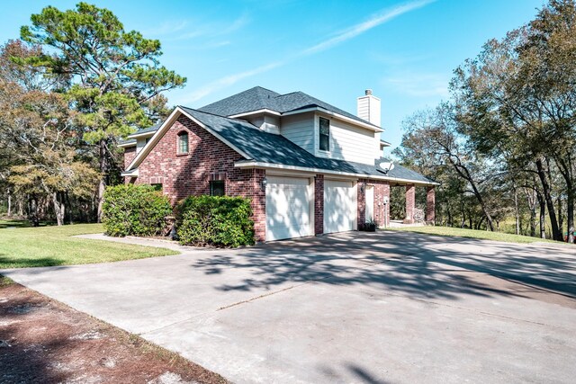 507 Oaks Grande Rd, Baytown, TX 77523 - view of home's exterior with brick siding, driveway, a chimney, a yard, and roof with shingles
