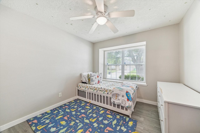 2515 Spring Dusk Ln, Spring, TX 77373 - bedroom featuring baseboards, wood finished floors, and ceiling fan