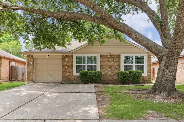 2515 Spring Dusk Ln, Spring, TX 77373 - view of front of house featuring driveway, a garage, and brick siding