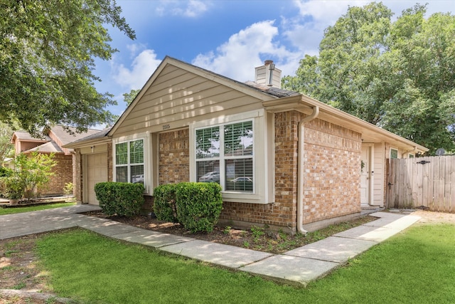 2515 Spring Dusk Ln, Spring, TX 77373 - view of home's exterior with brick siding, a chimney, and an attached garage