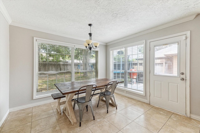 2515 Spring Dusk Ln, Spring, TX 77373 - dining space featuring ornamental molding, a chandelier, light tile patterned floors, baseboards, and a textured ceiling
