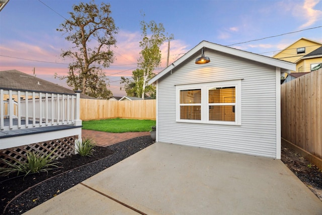 704 Cordell St, Houston, TX 77009 - patio terrace at dusk featuring a deck, a fenced backyard, and a patio area