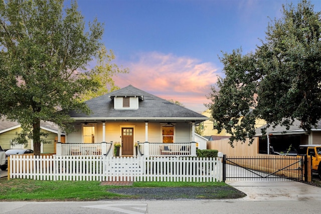 704 Cordell St, Houston, TX 77009 - bungalow-style house featuring a porch, ceiling fan, roof with shingles, and a fenced front yard