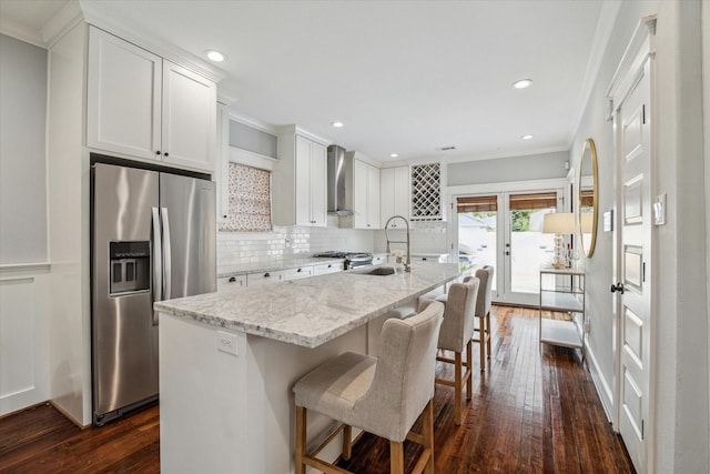 704 Cordell St, Houston, TX 77009 - kitchen featuring stainless steel refrigerator with ice dispenser, wall chimney range hood, dark wood-style flooring, an island with sink, and a sink