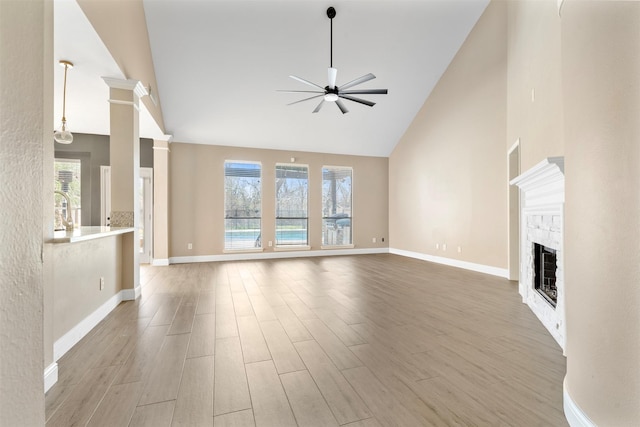 3106 Five Oaks Dr, Missouri City, TX 77459 - unfurnished living room with high vaulted ceiling, ceiling fan, light wood-style floors, and a fireplace