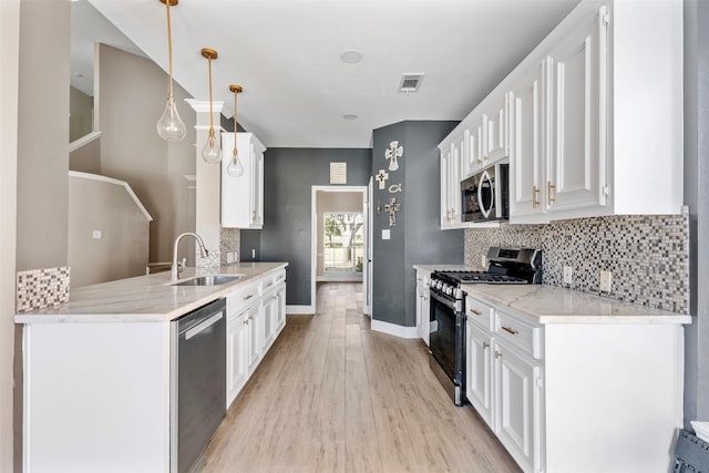 3106 Five Oaks Dr, Missouri City, TX 77459 - kitchen with stainless steel appliances, a peninsula, light wood-style flooring, tasteful backsplash, and white cabinets