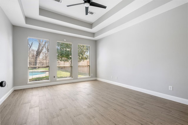 3106 Five Oaks Dr, Missouri City, TX 77459 - unfurnished room featuring wood finished floors, ceiling fan, and a tray ceiling