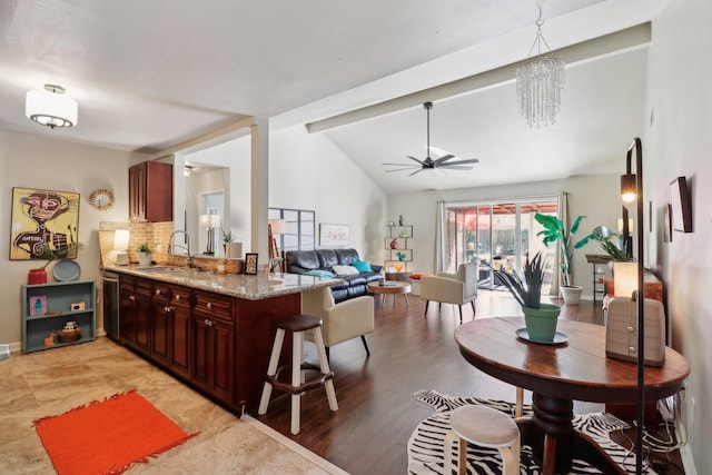 10711 Kirkside Dr, Houston, TX 77096 - kitchen with a sink, a ceiling fan, lofted ceiling, light stone countertops, and open floor plan
