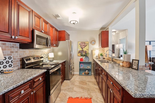 10711 Kirkside Dr, Houston, TX 77096 - kitchen with stainless steel appliances, a sink, and dark brown cabinets