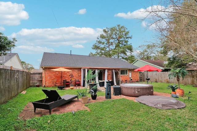 10711 Kirkside Dr, Houston, TX 77096 - back of house featuring a hot tub, brick siding, and a patio