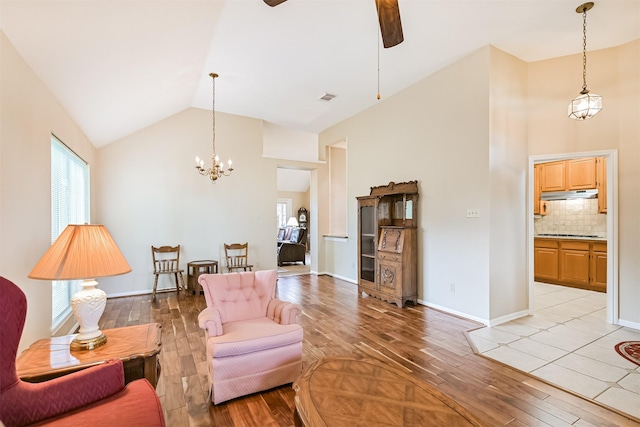 610 Bayou Bend Dr, Deer Park, TX 77536 - living area featuring light wood finished floors, ceiling fan, high vaulted ceiling, a chandelier, and baseboards