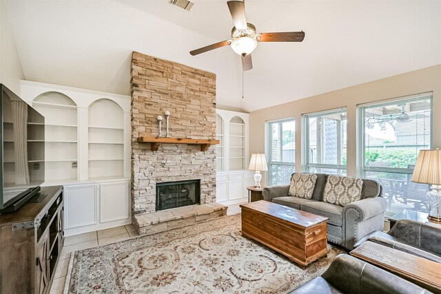 610 Bayou Bend Dr, Deer Park, TX 77536 - living room with ceiling fan, light tile patterned floors, built in features, high vaulted ceiling, and a fireplace