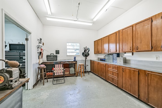 610 Bayou Bend Dr, Deer Park, TX 77536 - kitchen featuring brown cabinetry, concrete floors, and light countertops