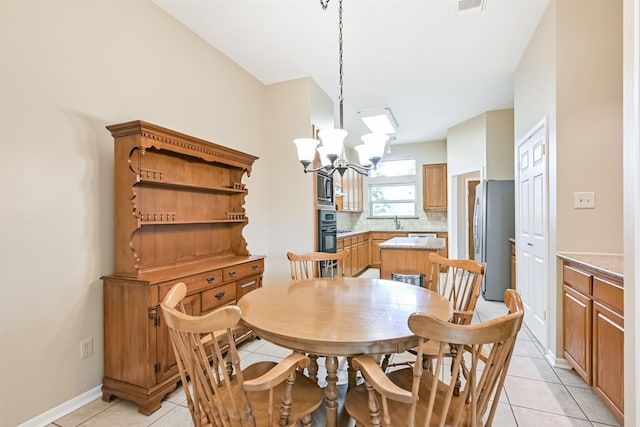610 Bayou Bend Dr, Deer Park, TX 77536 - dining space with light tile patterned floors, a chandelier, and baseboards