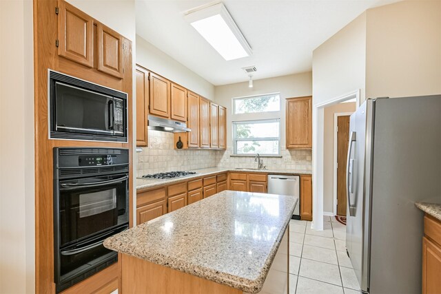 610 Bayou Bend Dr, Deer Park, TX 77536 - kitchen featuring black appliances, backsplash, a warming drawer, light stone countertops, and a sink