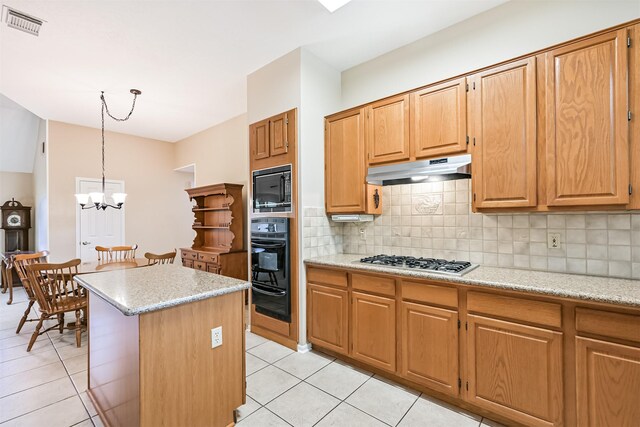 610 Bayou Bend Dr, Deer Park, TX 77536 - kitchen featuring black appliances, under cabinet range hood, light tile patterned floors, and tasteful backsplash