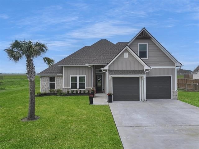 14845 Norma Jane Ln, Beaumont, TX 77713 - craftsman-style home featuring board and batten siding, driveway, roof with shingles, and an attached garage