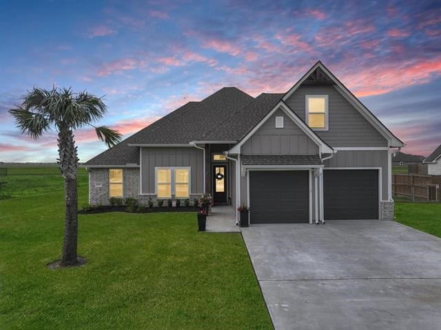 14845 Norma Jane Ln, Beaumont, TX 77713 - view of front of house with board and batten siding, concrete driveway, an attached garage, and a shingled roof