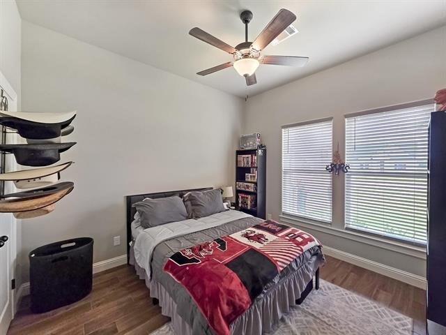 14845 Norma Jane Ln, Beaumont, TX 77713 - bedroom with wood finished floors, baseboards, and ceiling fan