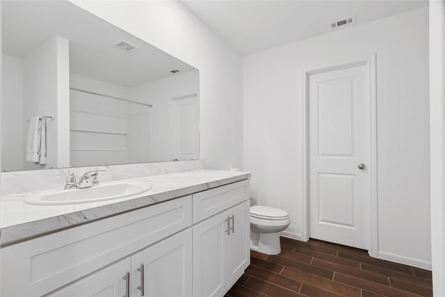21487 Austell Pond Dr, Porter, TX 77365 - full bathroom with vanity, wood finish floors, toilet, and a shower
