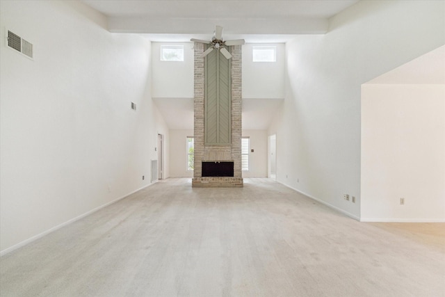2719 Williams Grant St, Sugar Land, TX 77479 - unfurnished living room with a towering ceiling, ceiling fan, baseboards, carpet flooring, and a fireplace