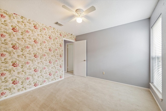 2719 Williams Grant St, Sugar Land, TX 77479 - unfurnished room featuring light carpet, ceiling fan, baseboards, and wallpapered walls