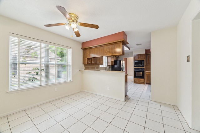 2719 Williams Grant St, Sugar Land, TX 77479 - kitchen featuring black appliances, light countertops, a peninsula, ceiling fan, and a sink