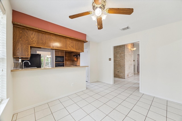 2719 Williams Grant St, Sugar Land, TX 77479 - kitchen featuring black appliances, a ceiling fan, light tile patterned floors, light countertops, and baseboards