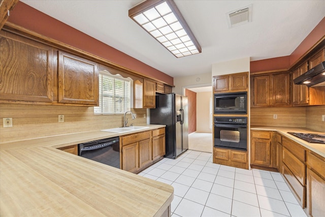 2719 Williams Grant St, Sugar Land, TX 77479 - kitchen with black appliances, a sink, light countertops, light tile patterned floors, and tasteful backsplash