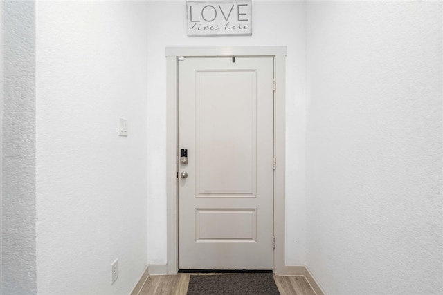 8219 Molasses Way, Rosharon, TX 77583 - doorway with light wood finished floors and baseboards