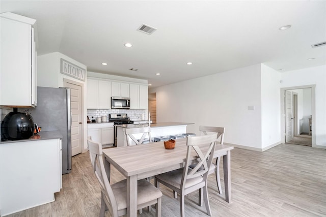 8219 Molasses Way, Rosharon, TX 77583 - dining room with light wood-type flooring, recessed lighting, and baseboards