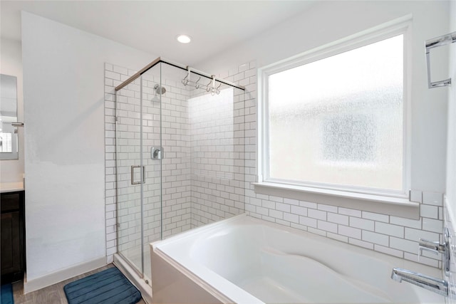 8219 Molasses Way, Rosharon, TX 77583 - full bath featuring healthy amount of natural light, a garden tub, a shower stall, vanity, and recessed lighting