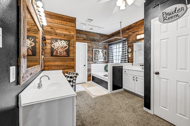5234 Teal Way, Baytown, TX 77523 - full bath with wooden walls, two vanities, a ceiling fan, and rail lighting