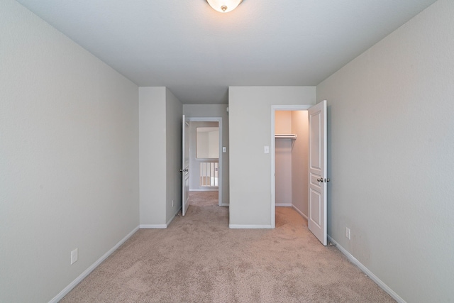 16659 Bluefin St, Crosby, TX 77532 - unfurnished bedroom featuring light colored carpet, baseboards, a walk in closet, and a closet
