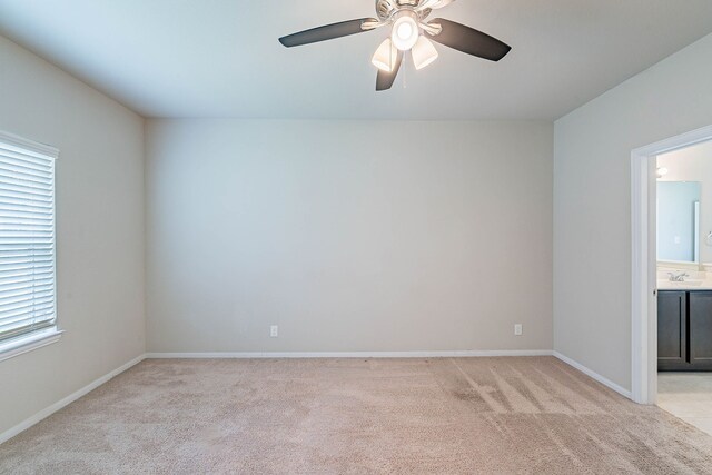 16659 Bluefin St, Crosby, TX 77532 - unfurnished room with light carpet, baseboards, a ceiling fan, and a sink