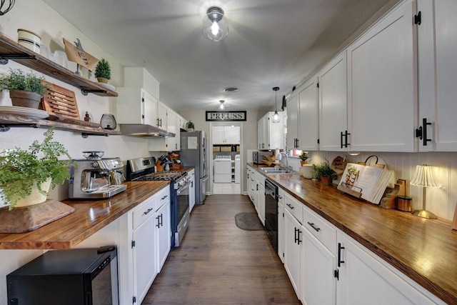 507 Sandra Dr, Brenham, TX 77833 - kitchen with wooden counters, appliances with stainless steel finishes, open shelves, under cabinet range hood, and washer and dryer
