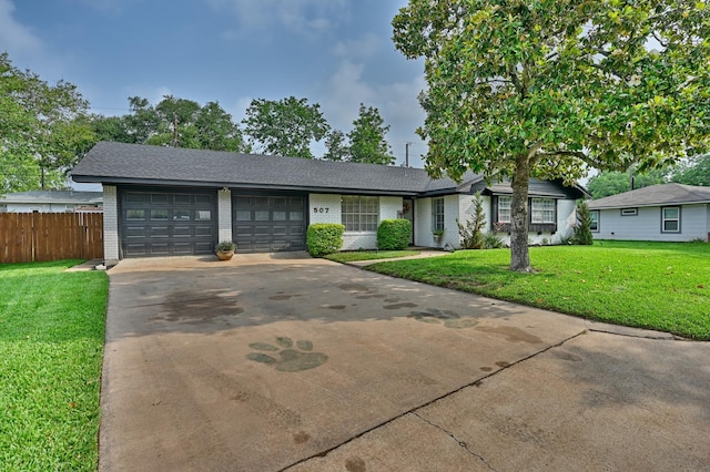 507 Sandra Dr, Brenham, TX 77833 - view of front facade with brick siding, an attached garage, concrete driveway, and a shingled roof