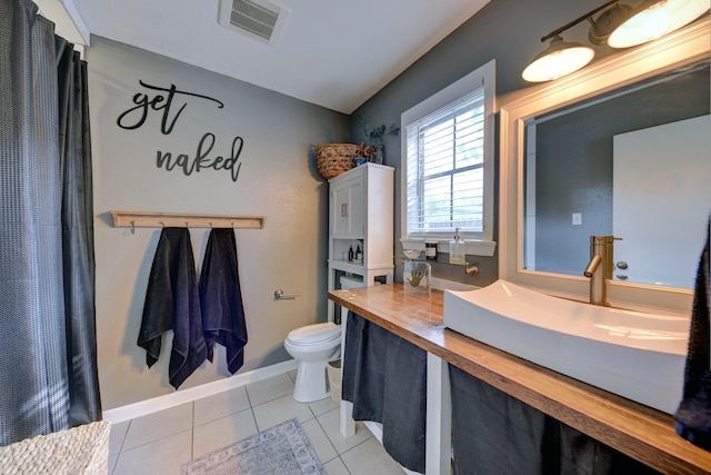507 Sandra Dr, Brenham, TX 77833 - full bathroom with toilet, tile patterned floors, vanity, and baseboards