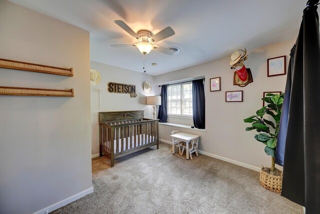 507 Sandra Dr, Brenham, TX 77833 - carpeted bedroom with baseboards, ceiling fan, and a nursery area