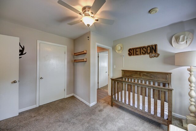 507 Sandra Dr, Brenham, TX 77833 - bedroom featuring carpet floors, a nursery area, ceiling fan, and baseboards