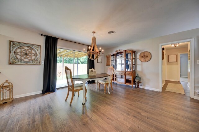 507 Sandra Dr, Brenham, TX 77833 - dining area with a chandelier, wood finished floors, and baseboards